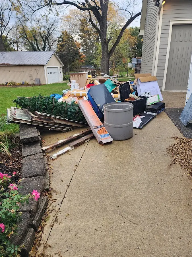 Dumpster being loaded with debris for 3 Yard Dumpster Rental in Farmington Hills
